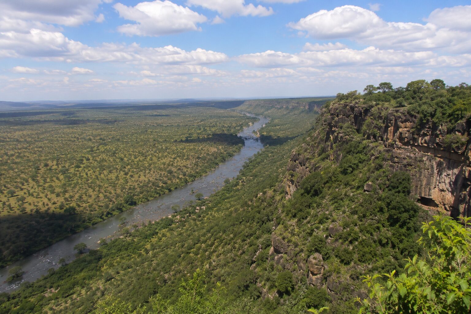 Luxury tented camp deck overlooking a river at dusk